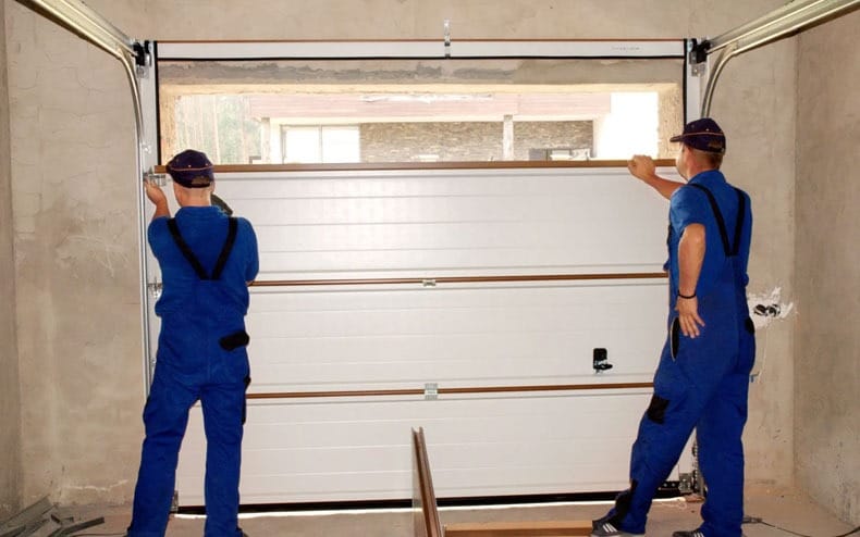 Garage door repair being done by professional technicians